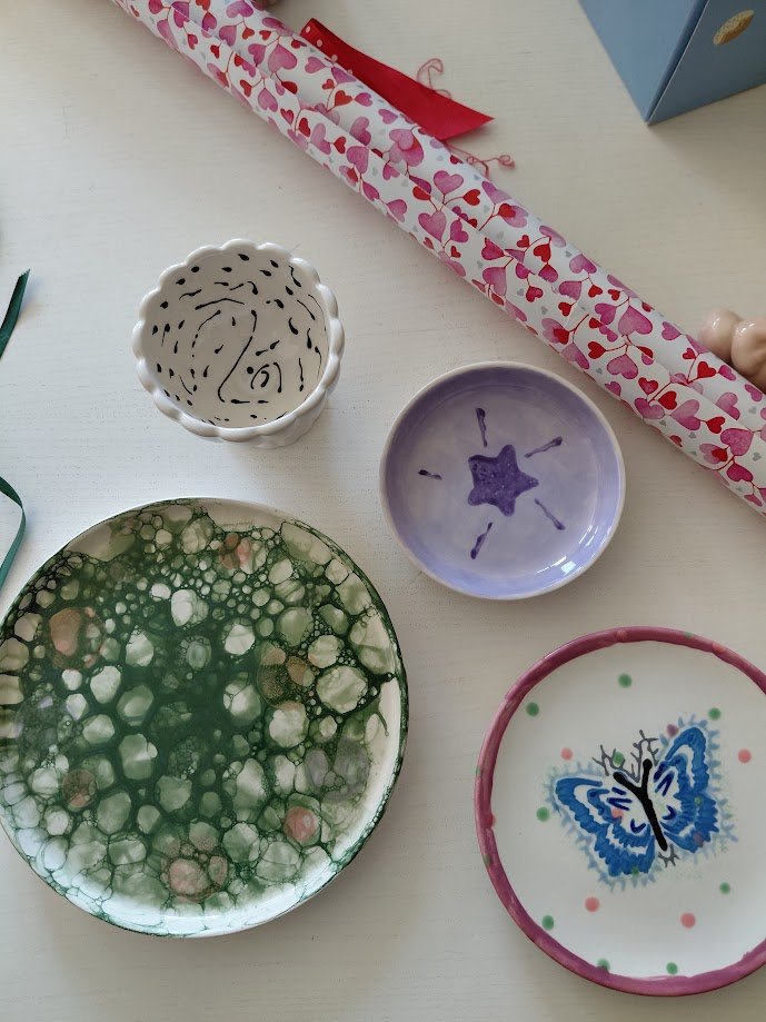 Four pieces of home painted ceramic results of the Birthday Party.