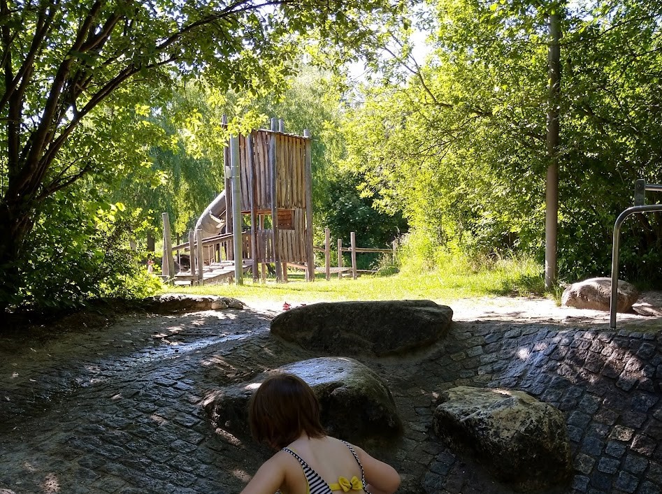 Playground with water in the area.